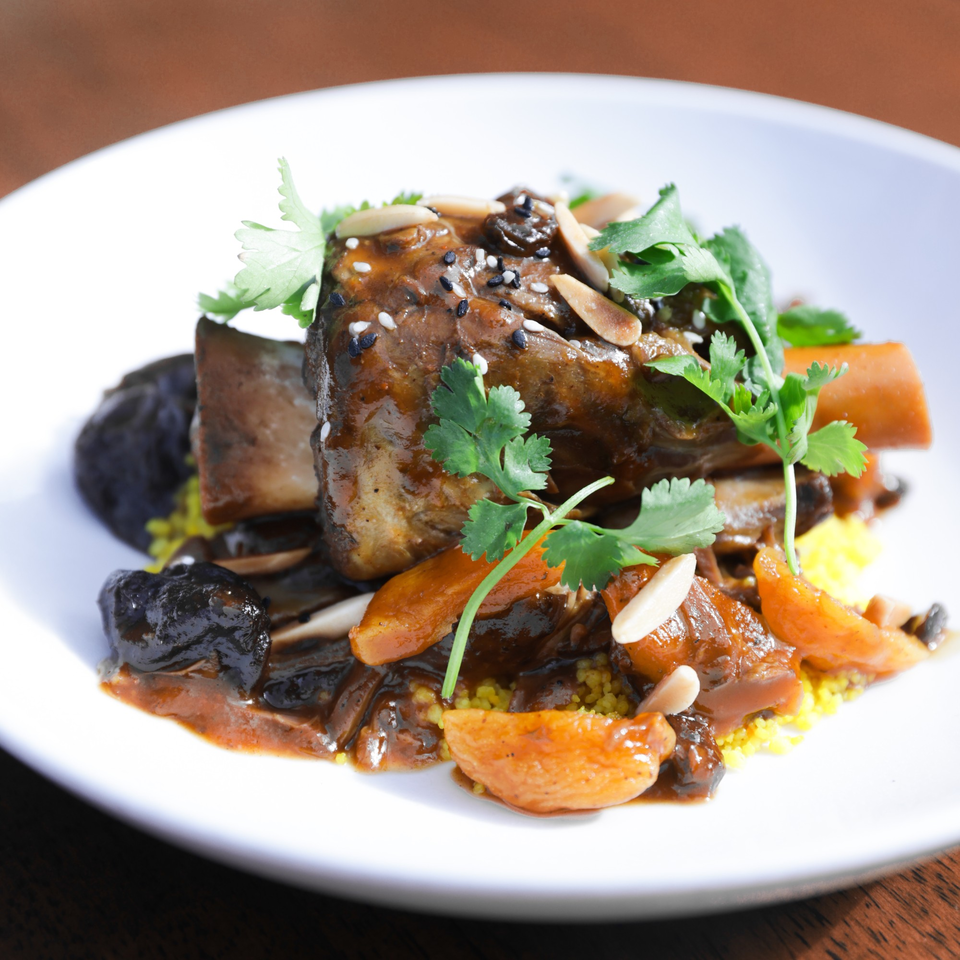 Braised short ribs with apricots, mushrooms, almonds, and cilantro on a bed of couscous.